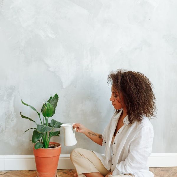 Woman meditating peacefully in a bright, clean environment.
